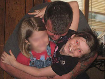 Adam Baker hugs his daughter Zahra and another girl, whose identity is being protected. (Source: MySpace)