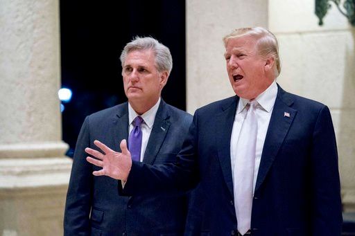 (AP Photo/Andrew Harnik). In this Jan. 14, 2018, photo, President Donald Trump, right, accompanied by House Majority Leader Kevin McCarthy, R-Calif., speaks to members of the media as they arrive for a dinner at Trump International Golf Club.