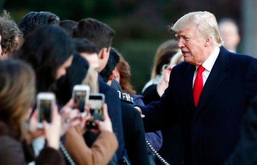 (AP Photo/Carolyn Kaster). President Donald Trump greets people on the South Lawn to the White House in Washington, Thursday, Jan. 18, 2018, as he returns from Pittsburgh.