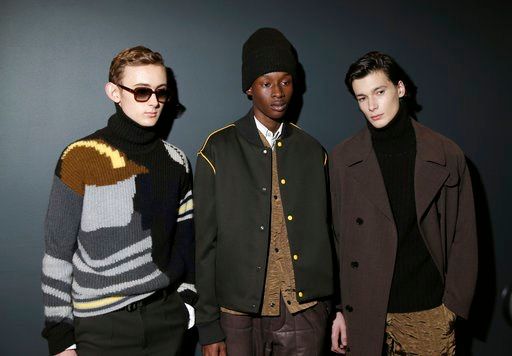 (AP Photo/Seth Wenig). Models pose for pictures before walking in the Hugo Boss fashion show during Fashion Week in New York, Wednesday, Feb. 7, 2018.