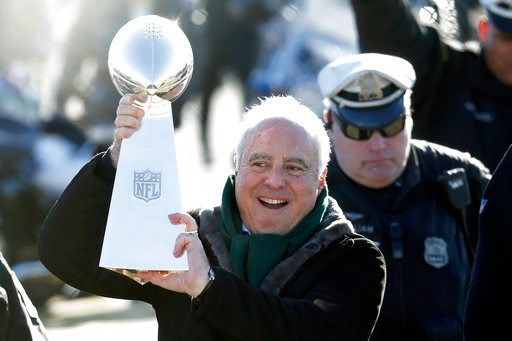 (AP Photo/Julio Cortez). Philadelphia Eagles owner Jeffrey Lurie carries the Vince Lombardi Trophy while walking to a fence to show it to fans gathered to welcome them in Philadelphia a day after defeating the New England Patriots in Super Bowl 52, Mon...