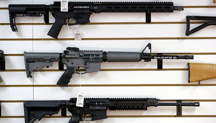A Ruger AR-15 semi-automatic rifle, center, sits on display with other rifles on a wall in a gun shop Tuesday, Nov. 7, 2017, in Lynnwood, Wa