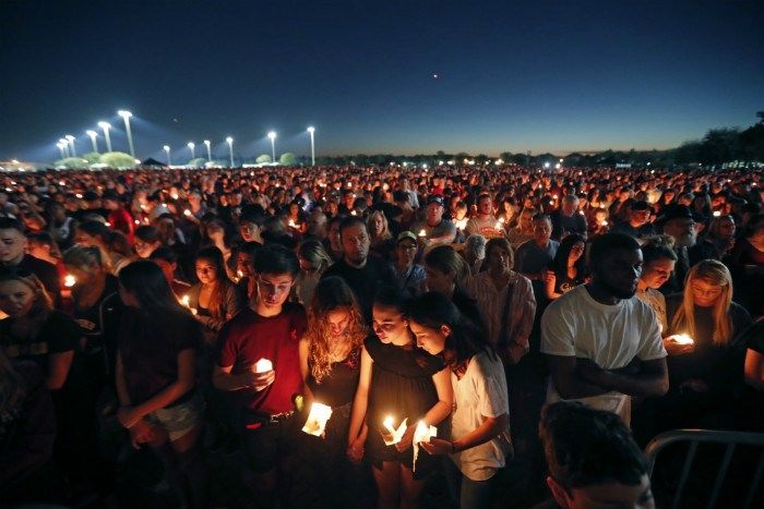 (AP Photo/Gerald Herbert) People attend a candlelight vigil for the victims of the Wednesday shooting at Marjory Stoneman Douglas High School, in Parkland, Fla., Thursday, Feb. 15, 2018. Nikolas Cruz, a former student, was charged with 17 counts of ...