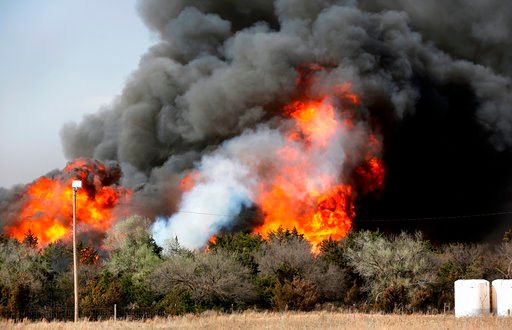 (Jim Beckel/The Oklahoman via AP). In this Tuesday, April 17, 2018, heavy smoke billows from burning trees after a wildfire broke out in a farm field along US Highway 183 about 10 miles south of Seiling, Okla.