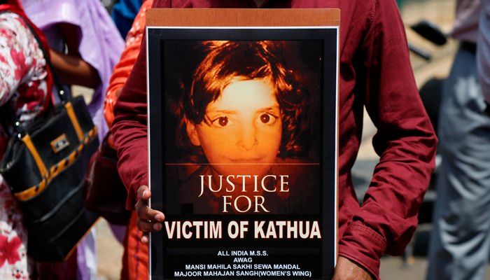 An Indian man holds a poster during a protest against recent incidents of rape and violence against women in Ahmadabad, India, Friday, April 13, 2018. (AP Photo/Ajit Solanki)