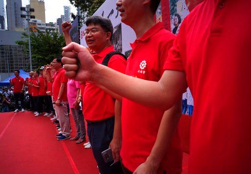 (AP Photo/Vincent Yu). Protesters shout slogans during a march to mark May Day in Hong Kong Tuesday, May 1, 2018. Hundreds of Hong Kong workers from various labor unions staged a rally to demand better workers' rights and call for standard working hours.