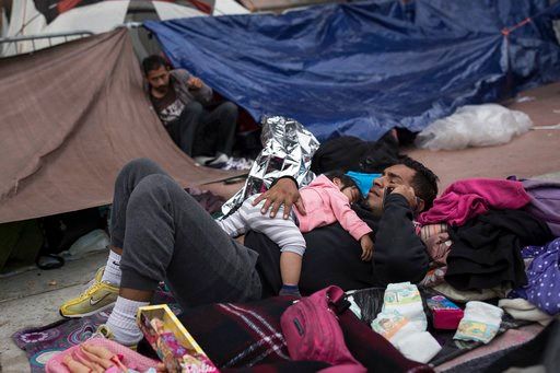 (AP Photo/Hans-Maximo Musielik). A migrant father and child, who traveled with the annual caravan of Central American migrants, rest where they set up camp to wait for access to request asylum in the US, outside the El Chaparral port of entry building.
