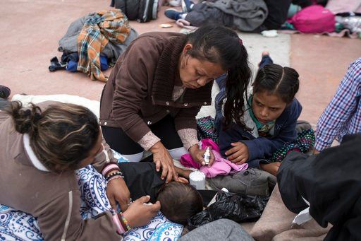(AP Photo/Hans-Maximo Musielik). A two-year-old child from Honduras gets treatment for an ear infection after sleeping in the open in front of the El Chaparral port of entry, in Tijuana, Mexico, Monday, April 30, 2018.
