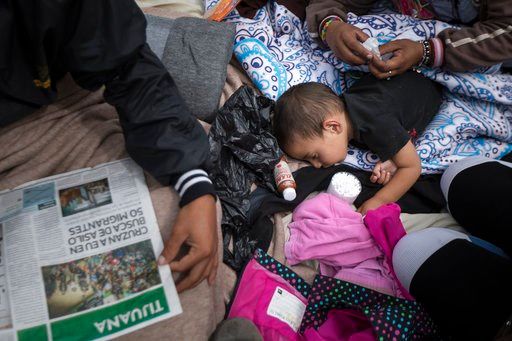 (AP Photo/Hans-Maximo Musielik). A two-year-old child from Honduras gets treatment for an ear infection after sleeping in the open in front of the El Chaparral port of entry, in Tijuana, Mexico, Monday, April 30, 2018.