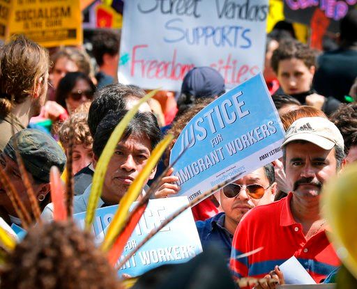 (AP Photo/Bebeto Matthews, File). In this Monday, May 1, 2017, file photo, people participate in a May Day rally in New York.