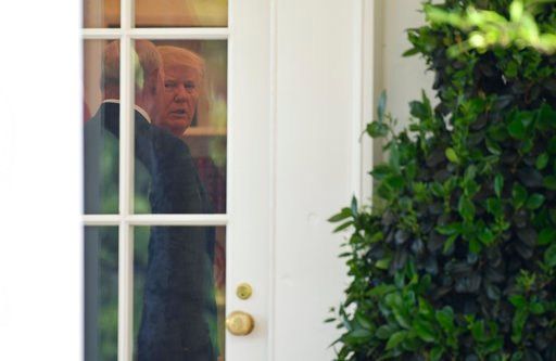 (AP Photo/Susan Walsh). President Donald Trump talks with White House Chief of Staff John Kelly in the Oval Office before the start of a National Day of Prayer event in the Rose Garden of the White House in Washington, Thursday, May 3, 2018. Rudy Giuli...