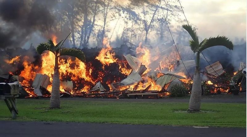 A Leilani Estates home is destroyed by lava roaring through the community. (Image: Greg Chunn)
