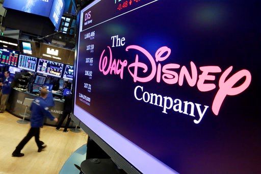 (AP Photo/Richard Drew, File). In this Aug. 8, 2017, file photo, The Walt Disney Co. logo appears on a screen above the floor of the New York Stock Exchange.