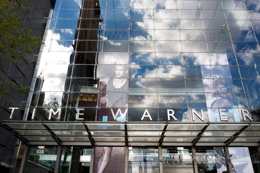 (AP Photo/Mark Lennihan, File). FILE - In this Oct. 24, 2016, file photo, clouds are reflected in the glass facade of the Time Warner building in New York. The judge presiding over the government's legal effort to block AT&amp;T's purchase of Time Warn...