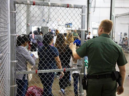(U.S. Customs and Border Protection's Rio Grande Valley Sector via AP). In this photo provided by U.S. Customs and Border Protection, a U.S. Border Patrol agent watches as people who've been taken into custody related to cases of illegal entry into the...