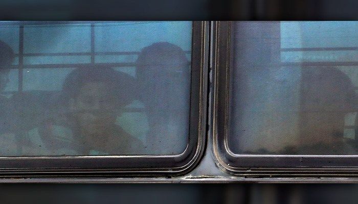 A boy stares out of a heavily tinted bus window leaving a U.S. Customs and Border Protection facility Tuesday in McAllen, TX. (AP Photo/Eric Gay)