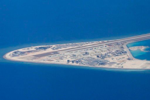 (Francis Malasig/Pool Photo via AP, File). FILE - In this April 21, 2017, file photo, Chinese structures and an airstrip on the man-made Subi Reef at the Spratly group of islands in the South China Sea are seen from a Philippine Air Force C-130. U.S. D...
