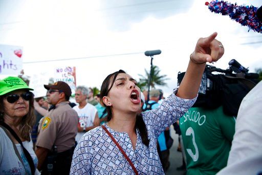 (AP Photo/Brynn Anderson). A protester yells toward a Trump supporter after arriving to the Homestead Temporary Shelter for Unaccompanied Children, on Saturday, June 23, 2018, in Homestead, Fla.