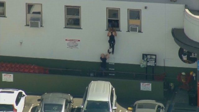 Officers have been helping people escape the store through windows with a rope ladder.
