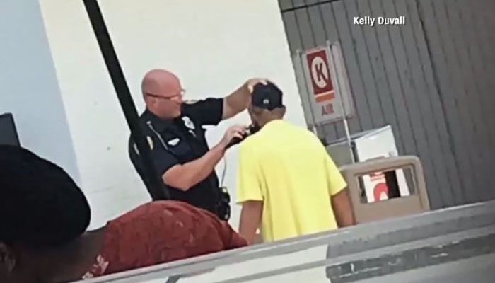 The officer shaved the man's beard after McDonald's told him they wouldn't hire him because of it. (Source: CNN/Kelly Duvall)
