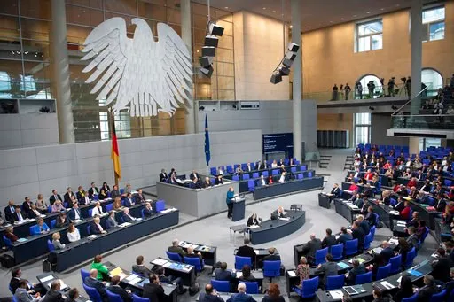 (Ralf Hirschberger/dpa via AP). FILE---In this picture taken Nov.21, 2018 German Chancellor Angela Merkel (CDU) speaks in the Bundestag.