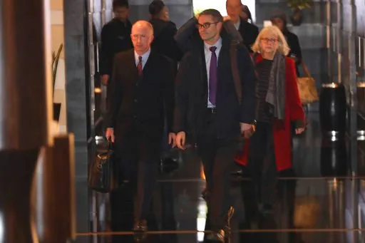 (AP Photo/Ng Han Guan). In this Sunday, Jan. 6, 2019, photo, members of a U.S. trade delegation including deputy U.S. trade representative, Jeffrey D. Gerrish, left, leave a hotel in Beijing. The U.S. delegation led by Gerrish arrived in the Chinese ca...