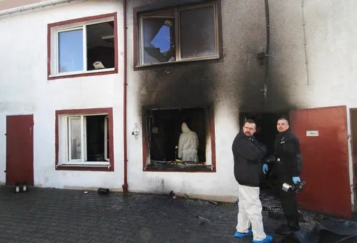 (AP Photo). Forensic and other police experts examine the site of a fire in an Escape Room, in Koszalin, northern Poland, on Saturday, Jan. 5, 2019. Investigators in Poland on Saturday blamed a gas leak in a heating system at an "Escape Room" for a fir...