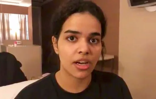 (Rahaf Mohammed Alqunun/Human Rights Watch via AP). In this Monday, Jan. 7, 2019, image made from video released by Rahaf Mohammed Alqunun/Human Rights Watch, Rahaf Mohammed Alqunun views her mobile phone as she sits barricaded in a hotel room at an in...