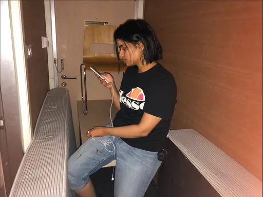 (Rahaf Mohammed Alqunun/Human Rights Watch via AP). In this Monday, Jan. 7, 2019, photo released by Rahaf Mohammed Alqunun/Human Rights Watch, Rahaf Mohammed Alqunun views her mobile phone as she sits barricaded in a hotel room at an international airp...